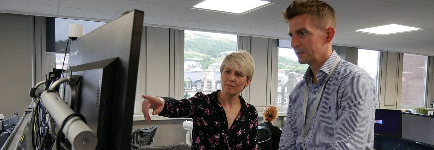 Two RoS colleagues looking at a computer screen 
