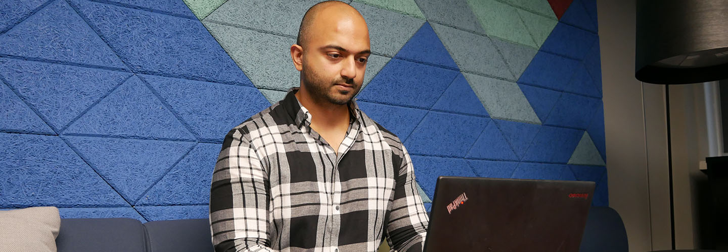 RoS colleague working against a blue background 