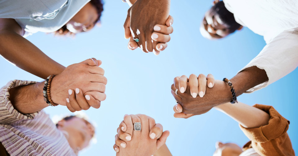 Image of people holding hands in a circle